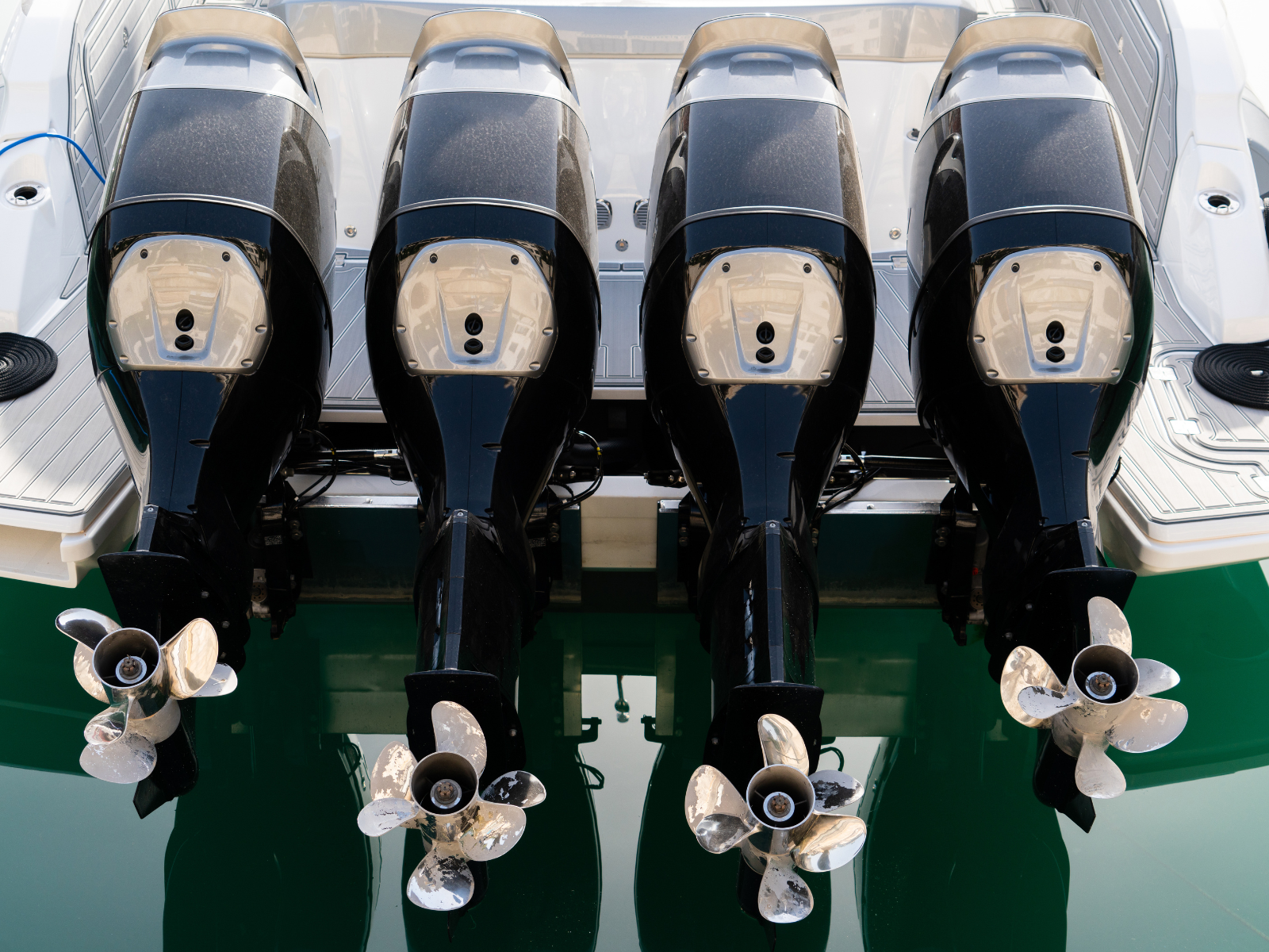 4 suzuki outdoor motors fit in the back of a boat in a bay in Cape Town by Atlantic Suzuki