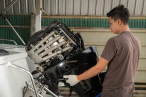 Technical specialist performing a Suzuki outboard motor service at Atlantic Suzuki Cape Town