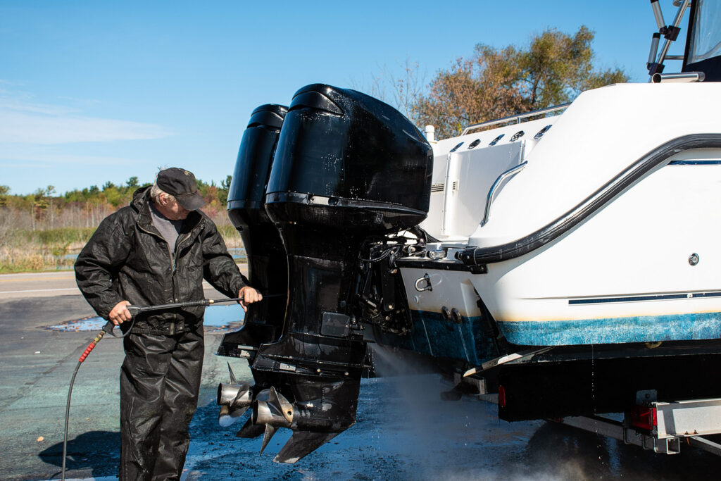 Outboard motors being pressure washed on a power boat